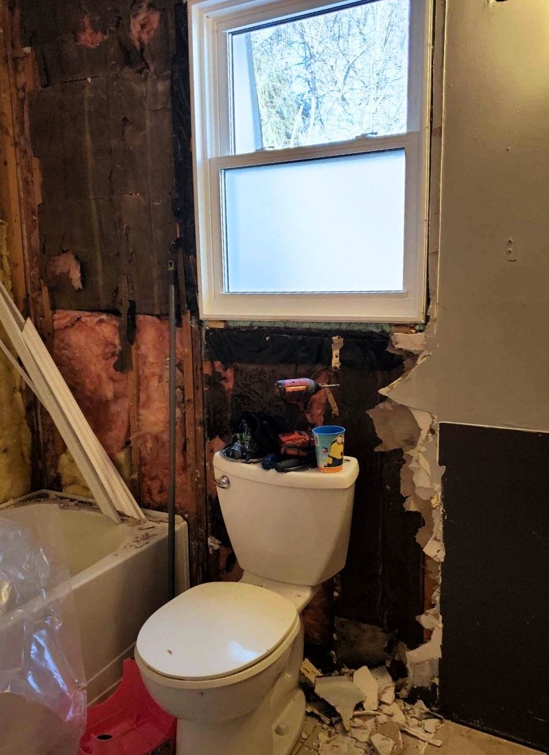 Drywall removed behind a tub